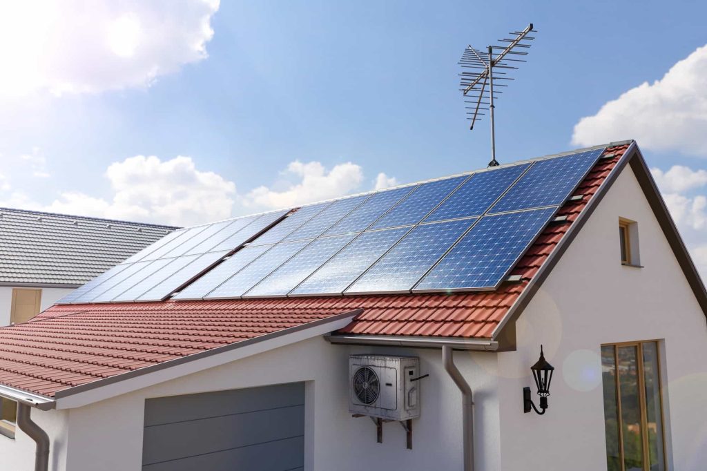 Solar panels on a sunlit house, harnessing renewable energy.